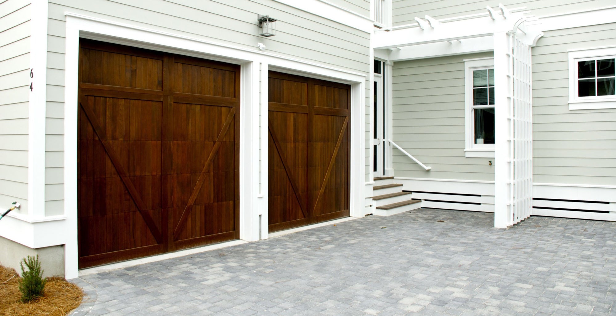 Exterior view of dark wood garage door installation