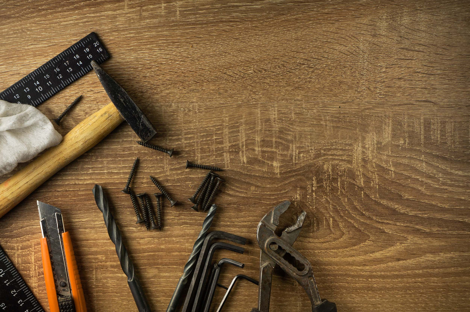 Lineup of garage door installation tools on a wood work bench